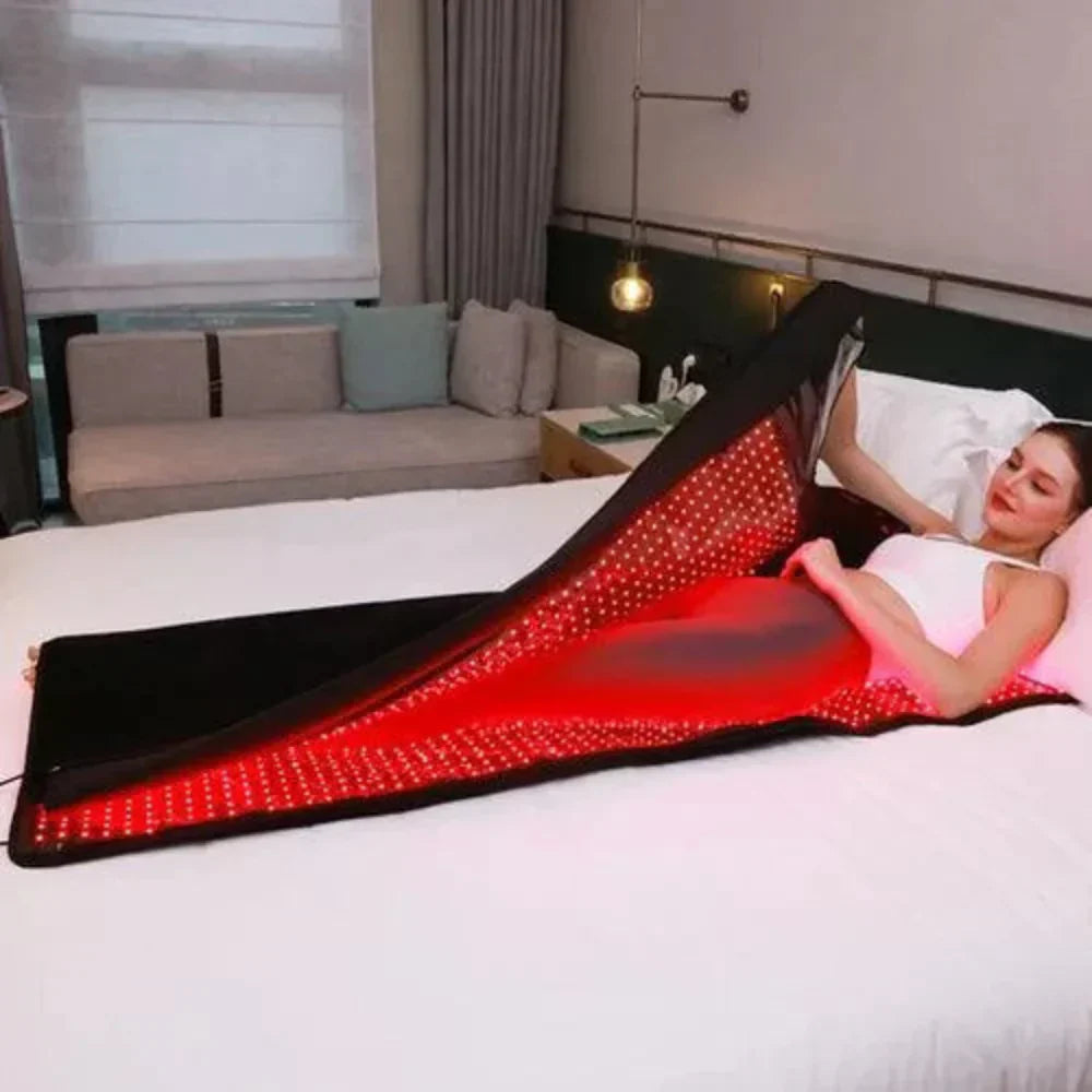 Red light therapy mat in use with glowing infrared LEDs in a spa setting.