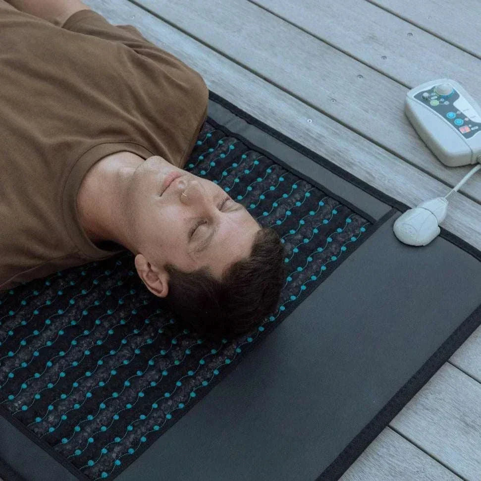 Electric PEMF massage mat with amethyst and jade, promoting relaxation and recovery.