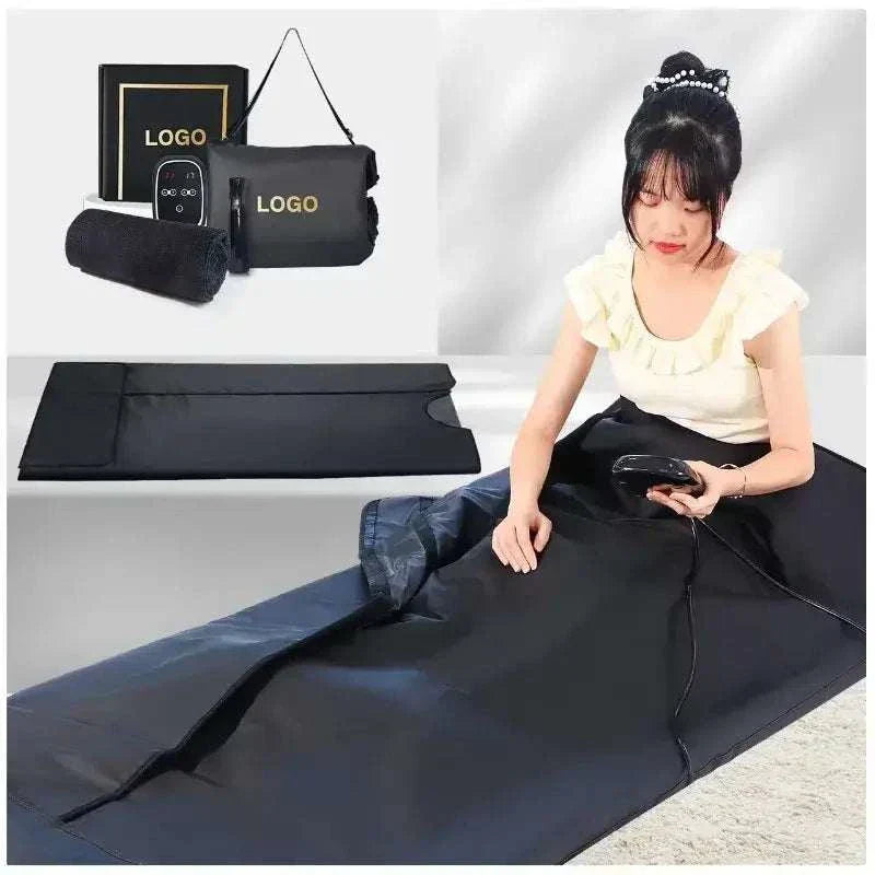 Infrared sauna blanket with accessories and user, PU leather, black, relaxation and detoxification benefits.
